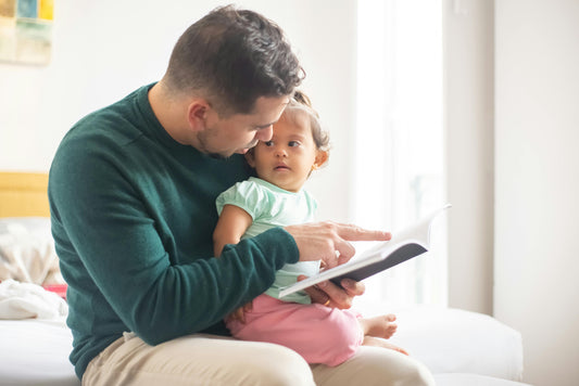 Baby and Dad reading book together