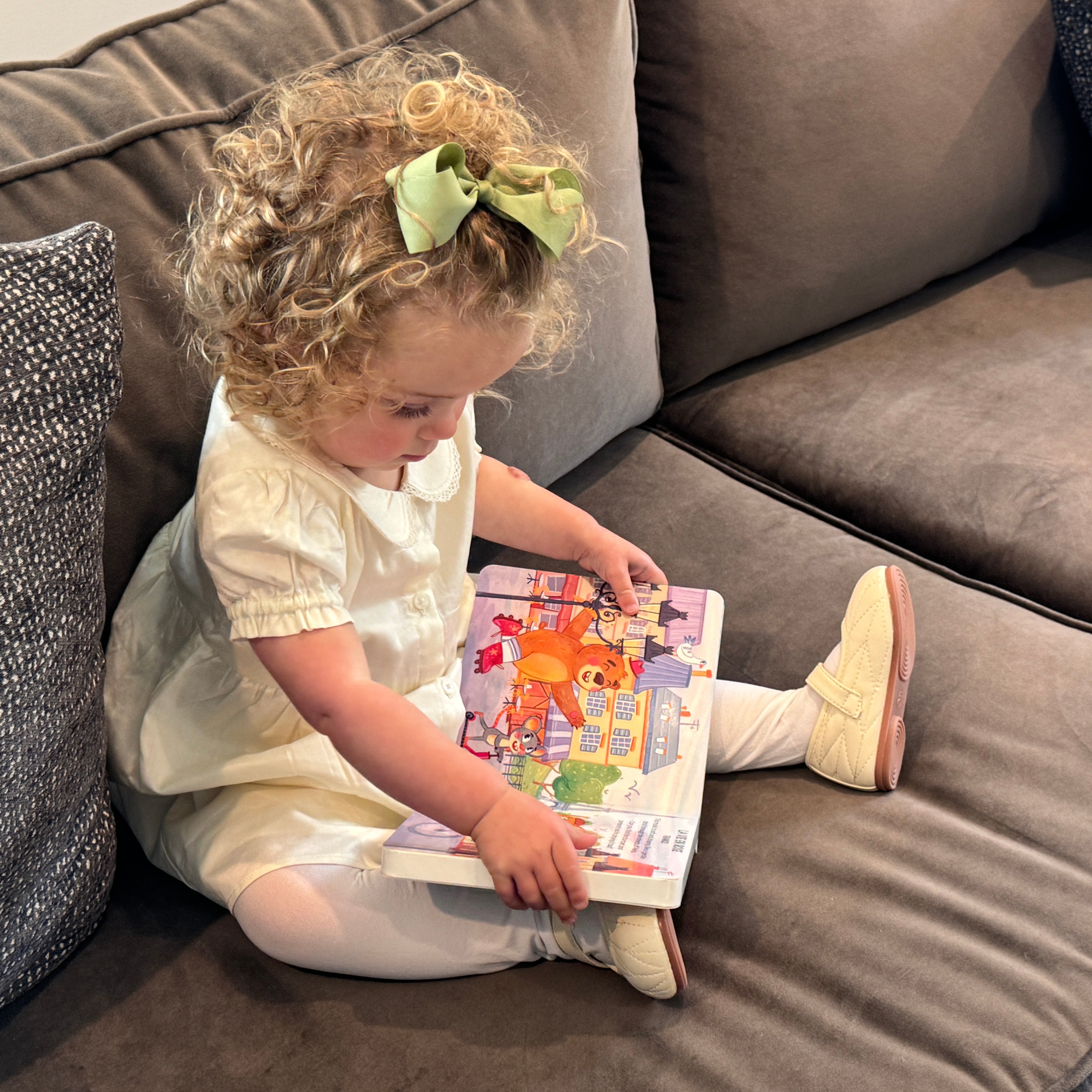 Toddler pressing button on world music book by Pirouette Kids