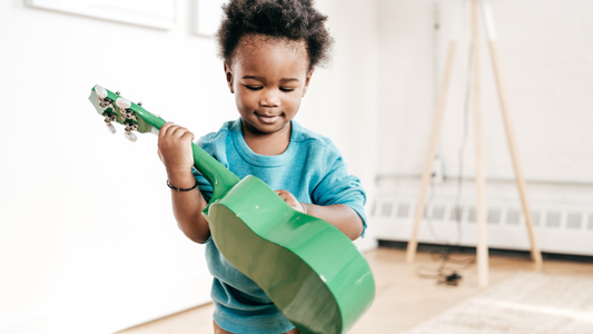 little boy playing guitar
