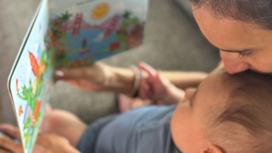 Mom and baby reading a musical book