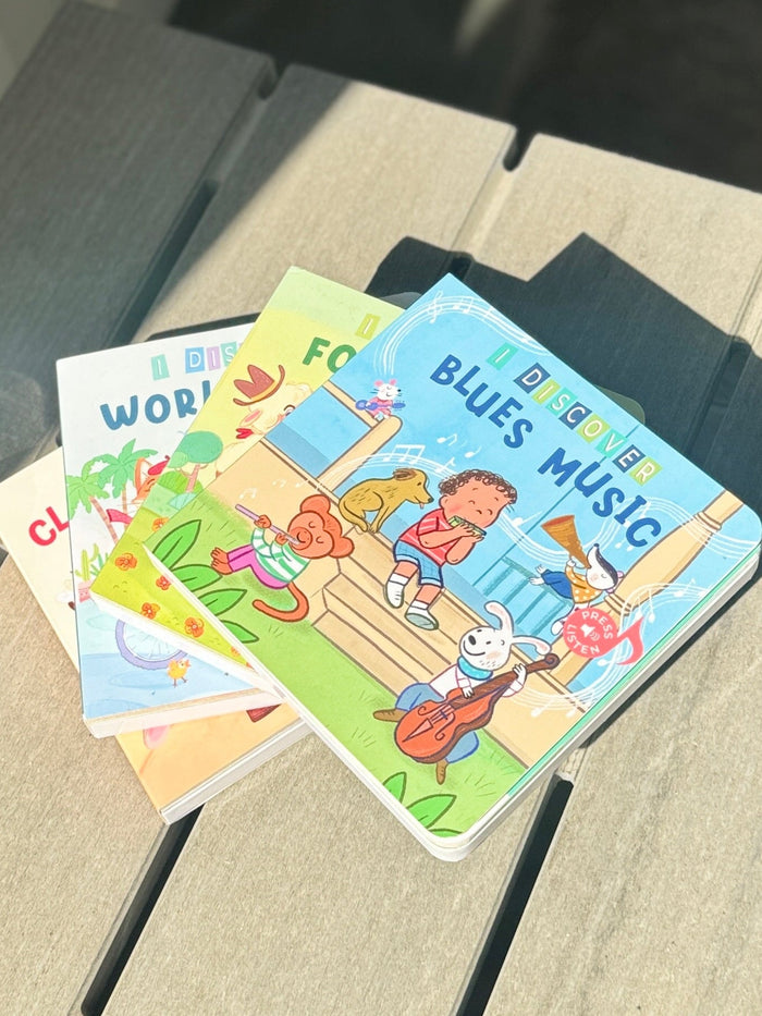 Children's books on a small wooden table outdoors
