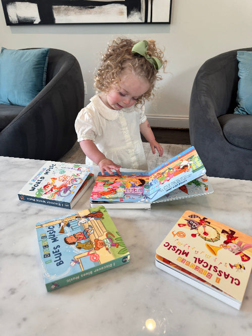 Toddler pressing button on Pirouette Kids folk music book