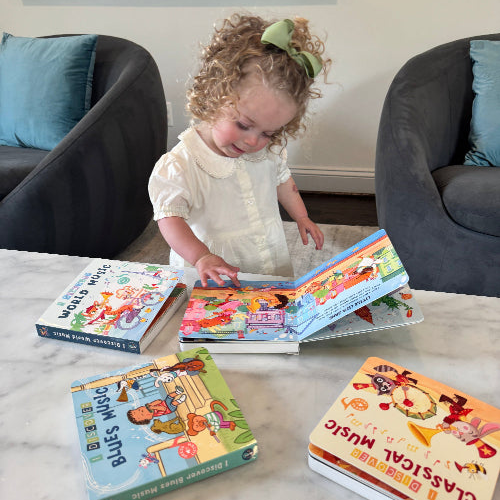 Child playing with Pirouette Kids board books on a table