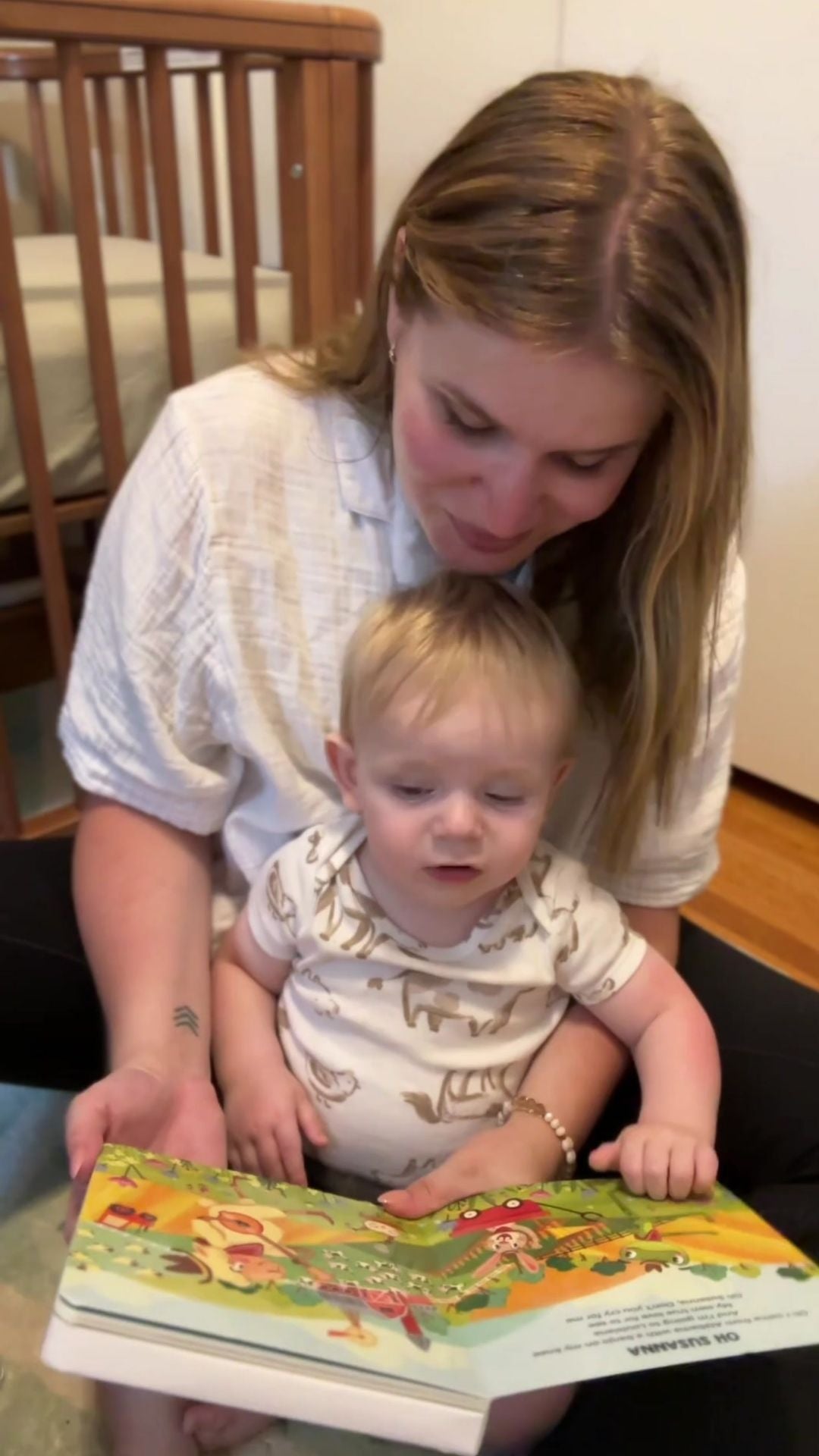 Mom reading Pirouette Kids Music Book to Baby at home